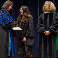 Faculty receiving award from Christine